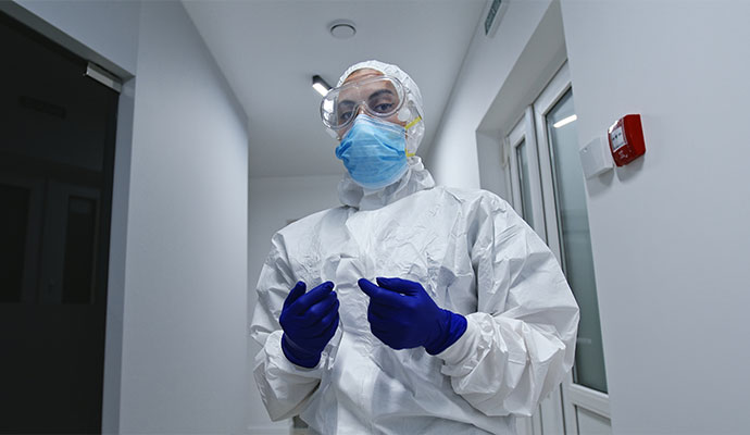 A professional with full hazmat suit