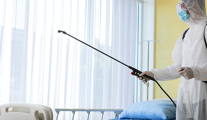 A professional disinfecting hospital room