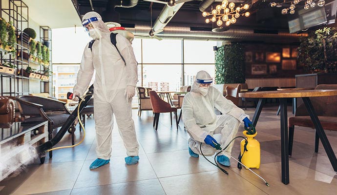 Professionals disinfecting a restaurant interior