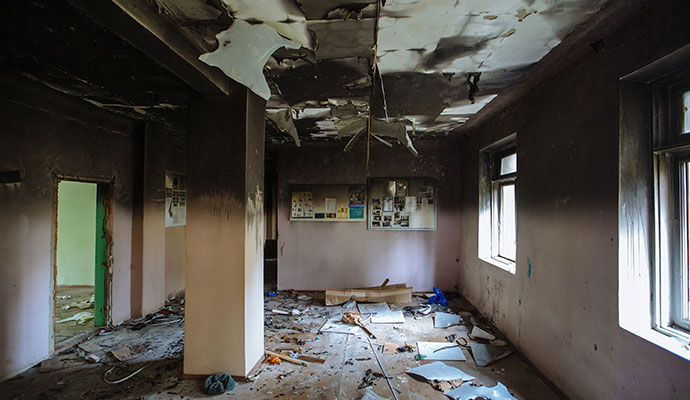 Fire damaged room wall and floor