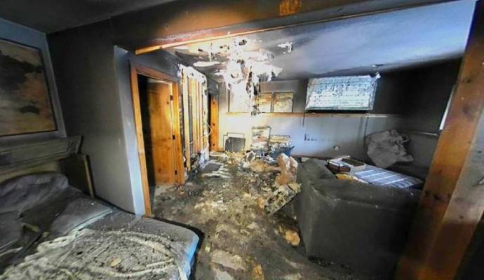 Inside view of a room with heavy fire damage.