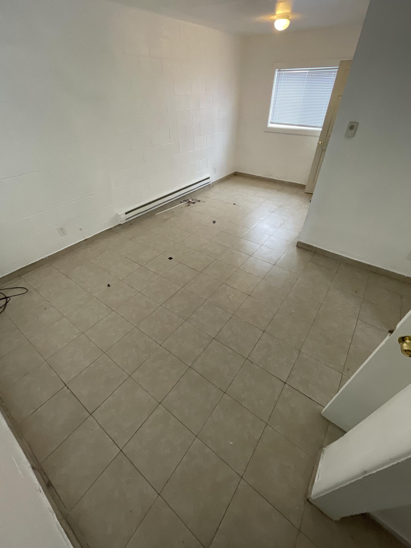 Bathroom with toilet, vanity, and shower stall in an apartment requiring fire damage restoration.