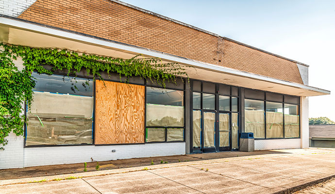Commercial building's windows and doors have been covered with boards