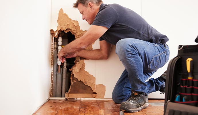 Professional worker repairing water pipe