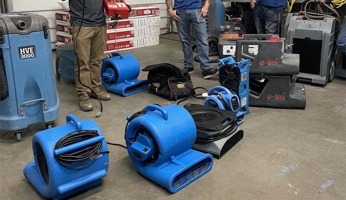 Professionals with drying equipment