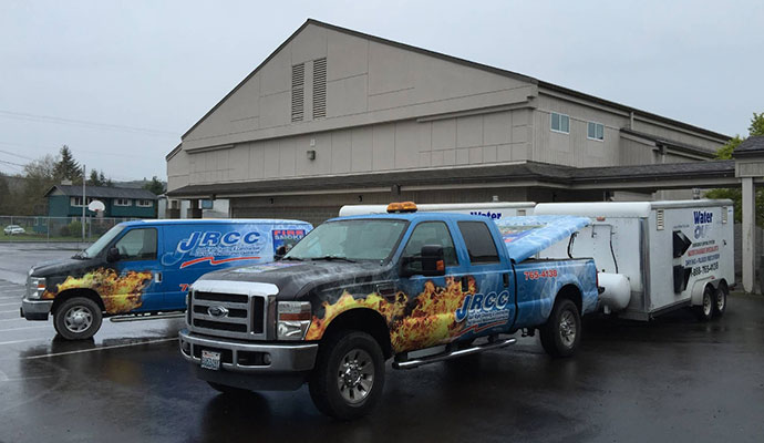 Just Right Cleaning and Construction van infront of factory buildings