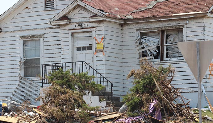 Storm damaged house and broken windows