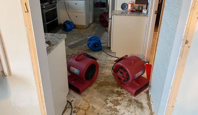 Four air movers drying water