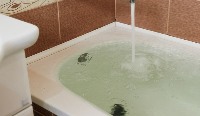 Bathtub overflowed by flood water