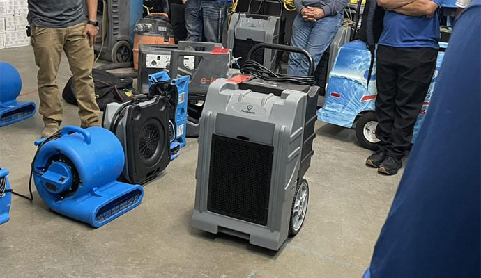 Commercial water restoration equipment, including a LGR dehumidifier and several blue centrifugal air movers