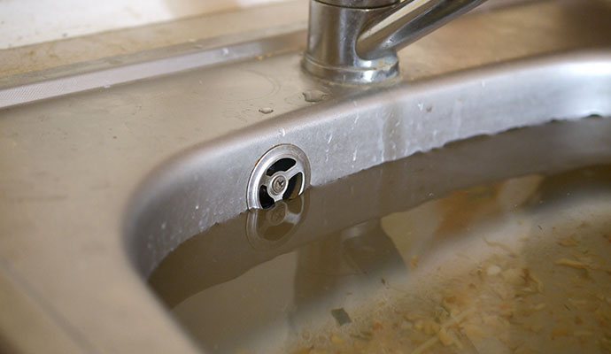 Kitchen sink clogged with water