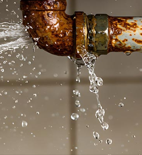 Water leaking from a rusty pipe